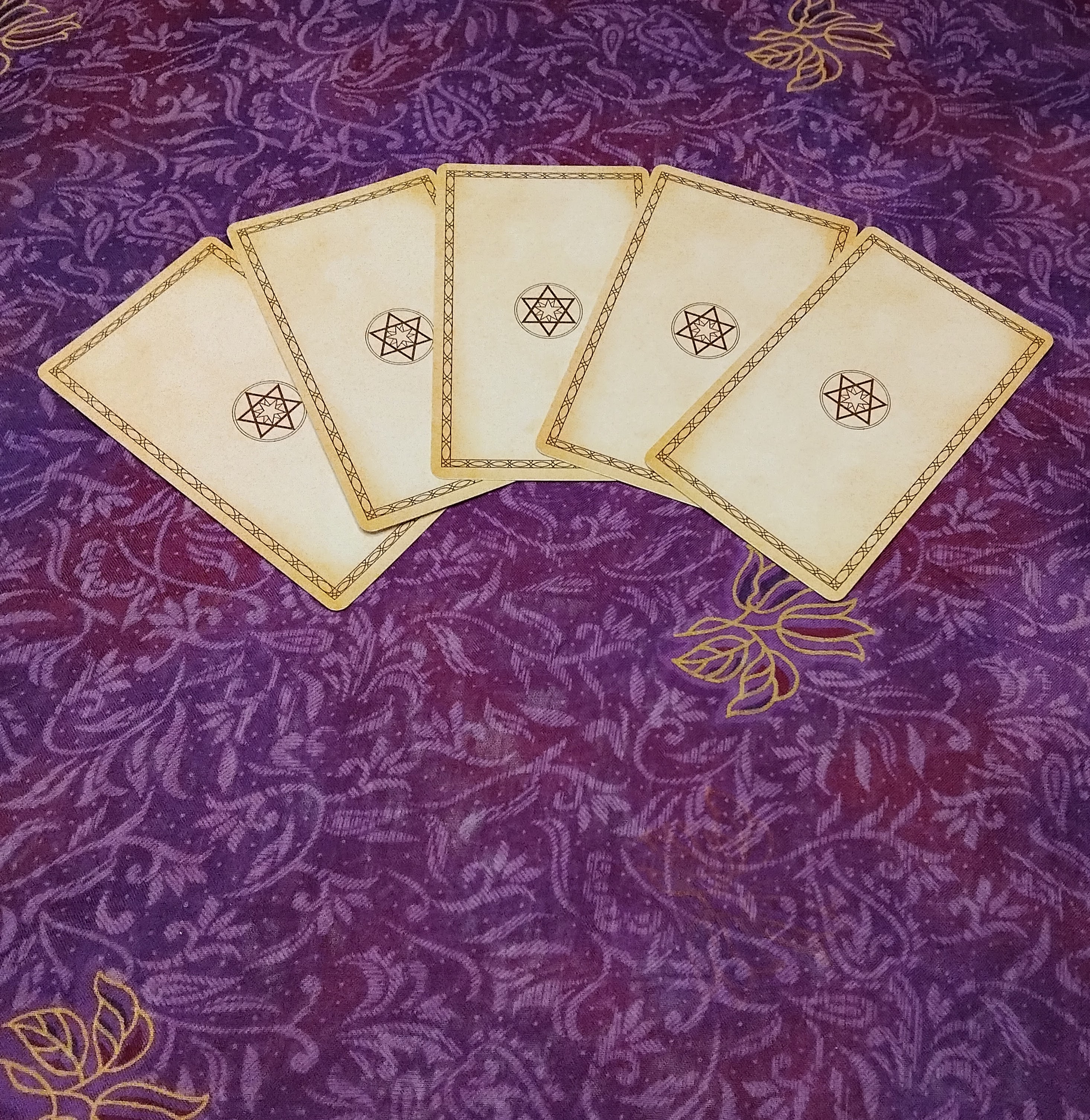 celectial cloth with 5 tarot cards face down